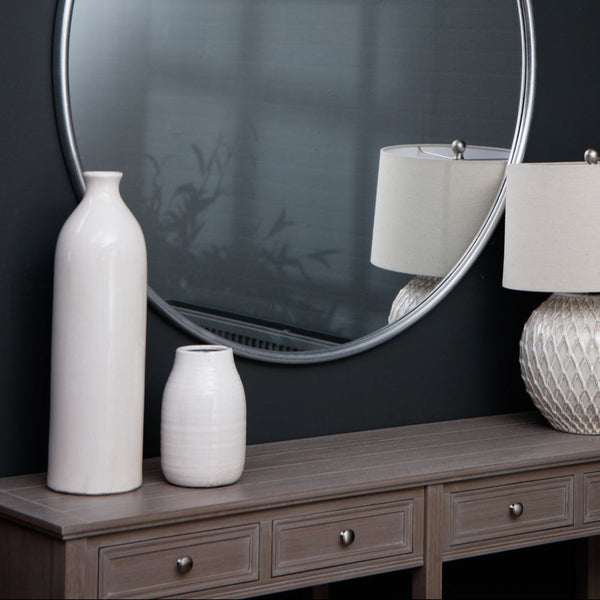 white ceramic crackled glazed vase with wide mouth. Sat on a wooden sideboard