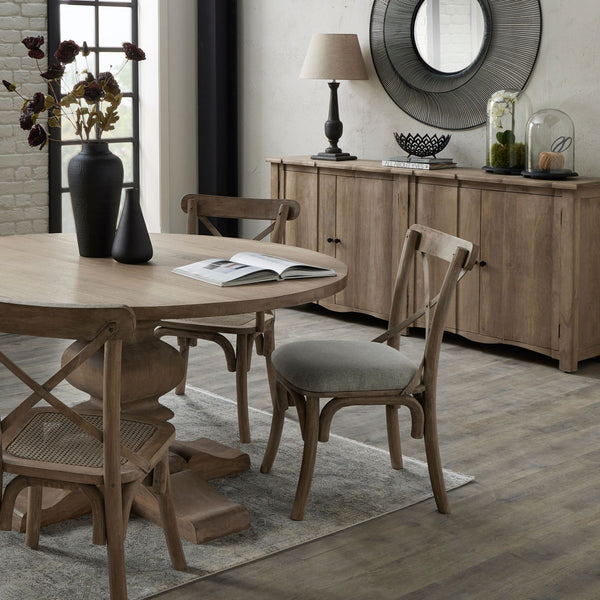 Cotswold 4 Door Wooden Sideboard sat in a dining room setting. Displaying a lamp and vases