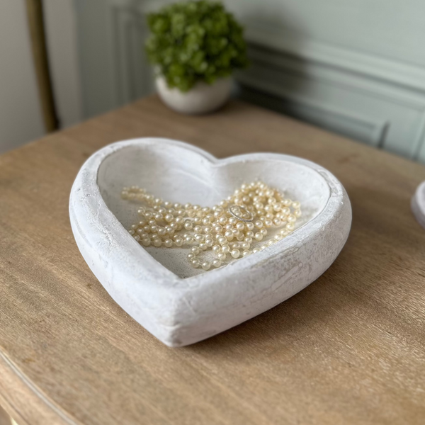 Deep Stone White Heart Dish with pearl beads stored inside. Sat on a wooden bedside table