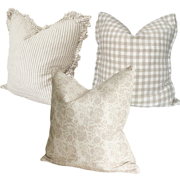 Set of 3 square cushions 1 ruffled edge linen cream with beige stripe cushion. 1 weathered edge cream and beige gingham linen cushion 1 square cream and beige floral print cotton cushion. All on plain white background