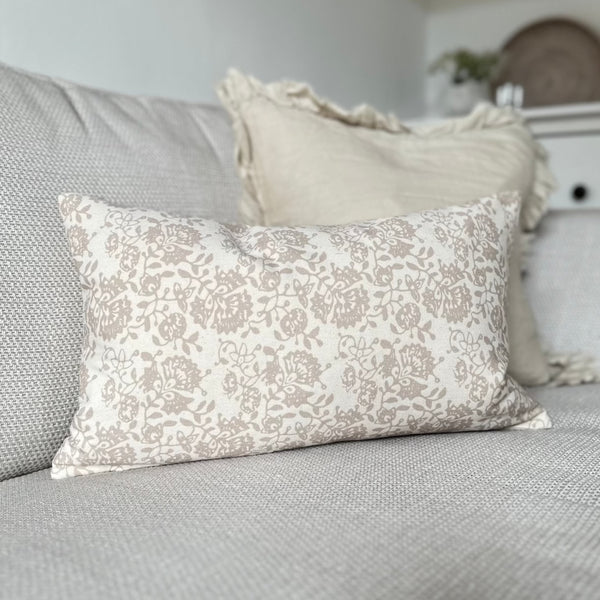 rectangle cream cushion with a beige floral print. 