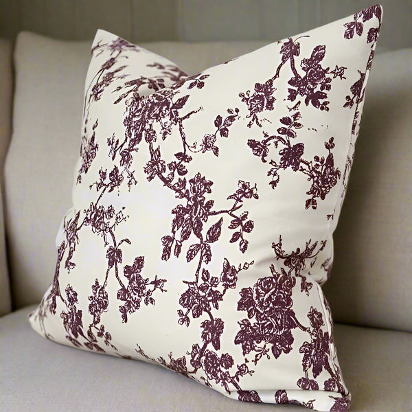 Plum Floral Print on a cream square cushion. Sat on a cream sofa