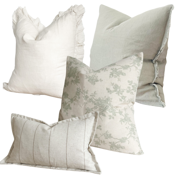 Set of 4 Cream and Sage green cushions. 1 square cream ruffled edge linen cushion, 1 weathered edge square sage green linen cushion, 1 square cotton, cream with a sage floral print cushion, 1 rectangle stone coloured cushion with a beige stripe. All sat on a plain white background